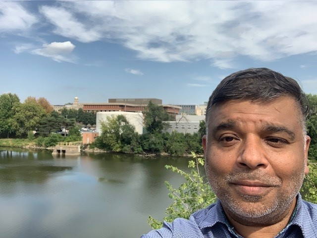 Photograph of Sandeep Burman by the Iowa River on the University of Iowa campus.