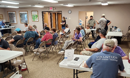 Photo showing attendees and volunteers at a well water screening clininc.